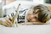 Boy Playing with Toy Dinosaur