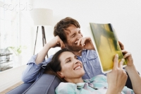 Young couple reading book together