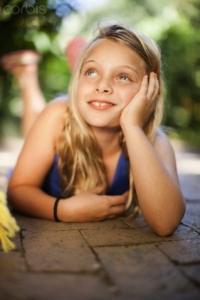 Girl laying on ground outdoors