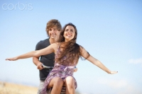 Couple riding bicycle outdoors