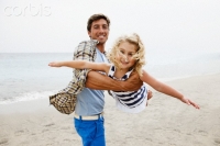 Father and daughter playing on beach