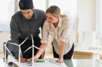 Architects looking at scale models of wind turbines