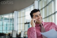 Businessman with document answering phone call